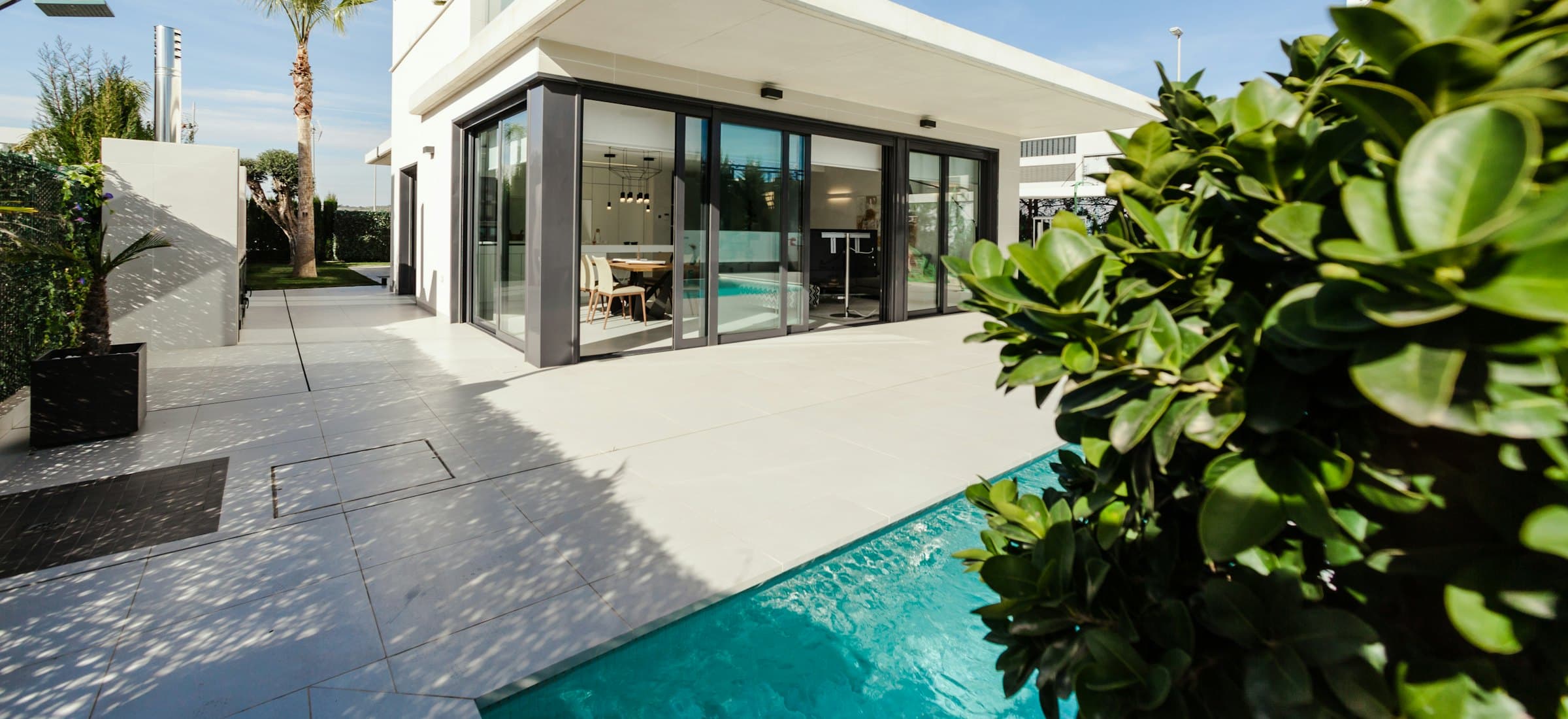 A contemporary property, its glazed frontage opening onto a terrace